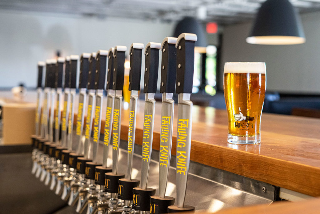 Falling Knife Brewing Co. tap handles and pint of beer